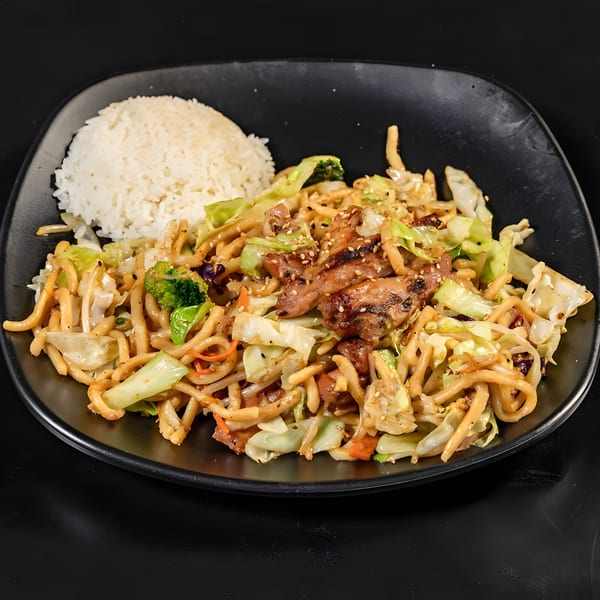 Teriyaki chicken and noodles with vegetables, served with a side of white rice on a black plate.